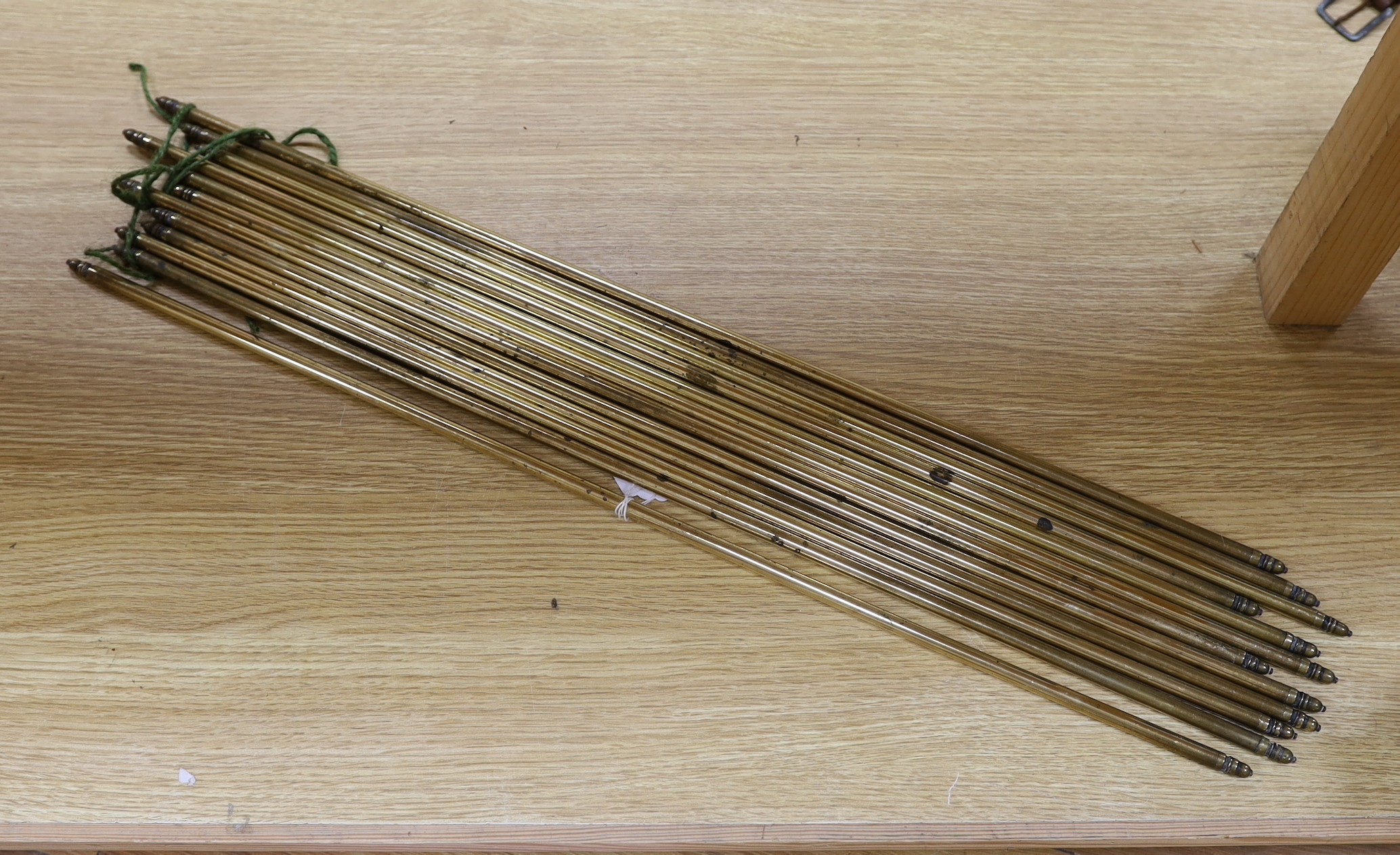 A set of twelve brass stair rods